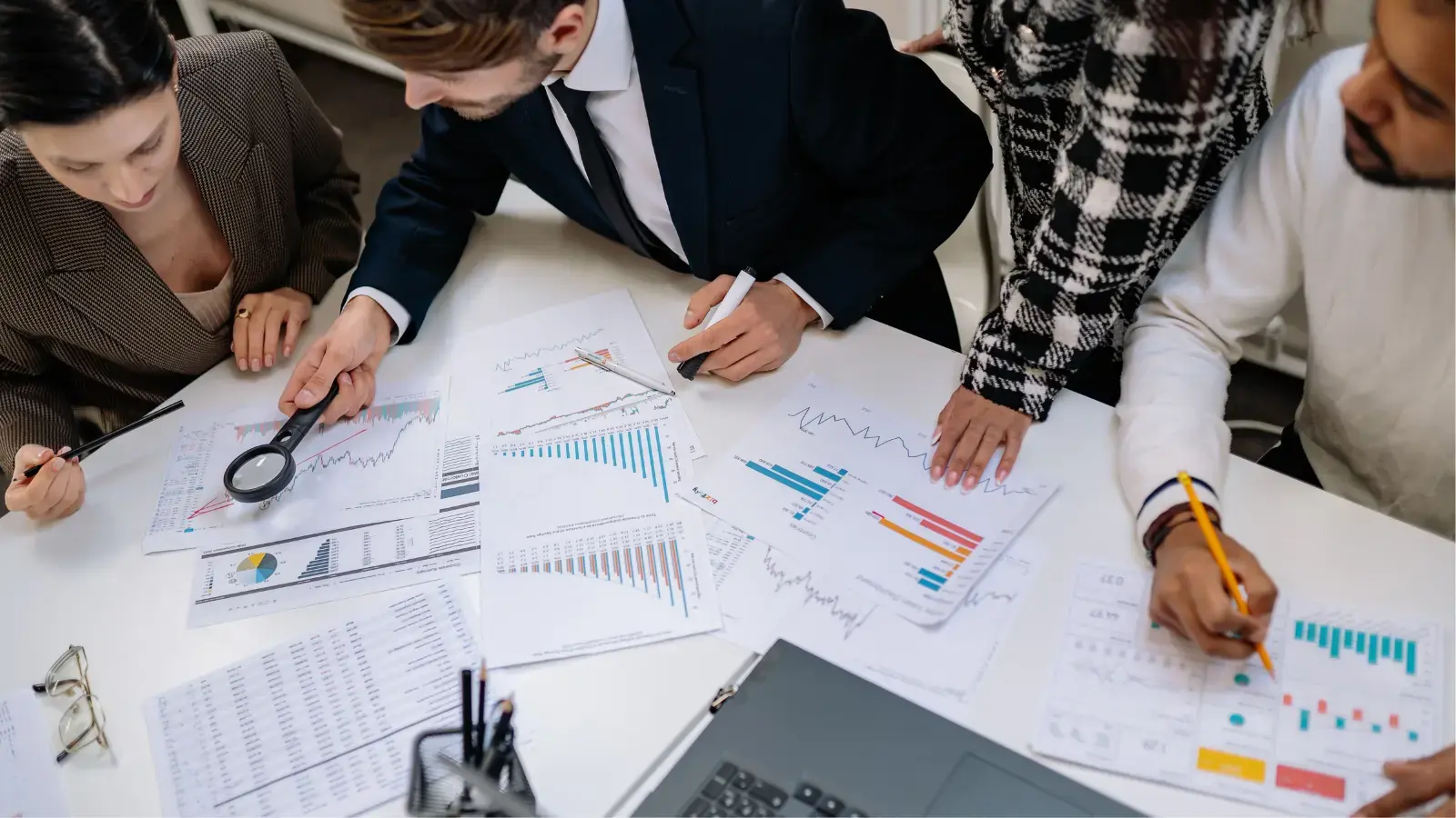 Build Intelligent AI Products That Drive Real Business Value Team discussing data charts in a meeting room