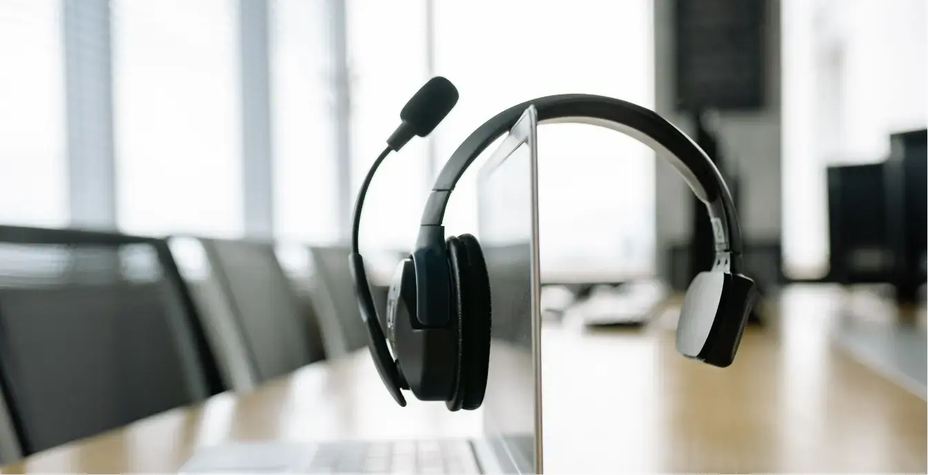 Benefits of AI Agent Development Support specialist with a headset working at a computer