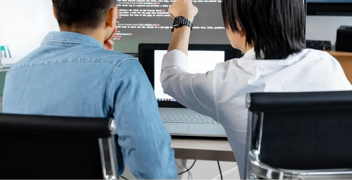 Benefits of Custom Software Development Developers reviewing code together