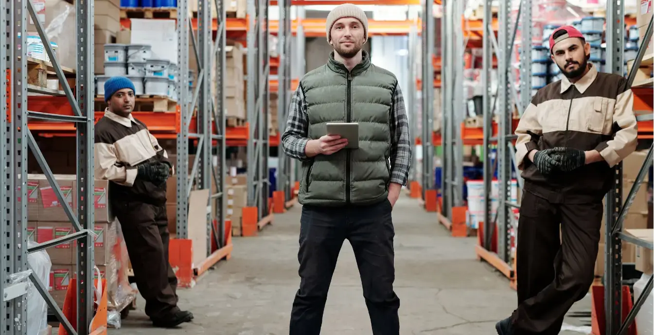Custom ERP Development Services Warehouse manager checking inventory on a tablet