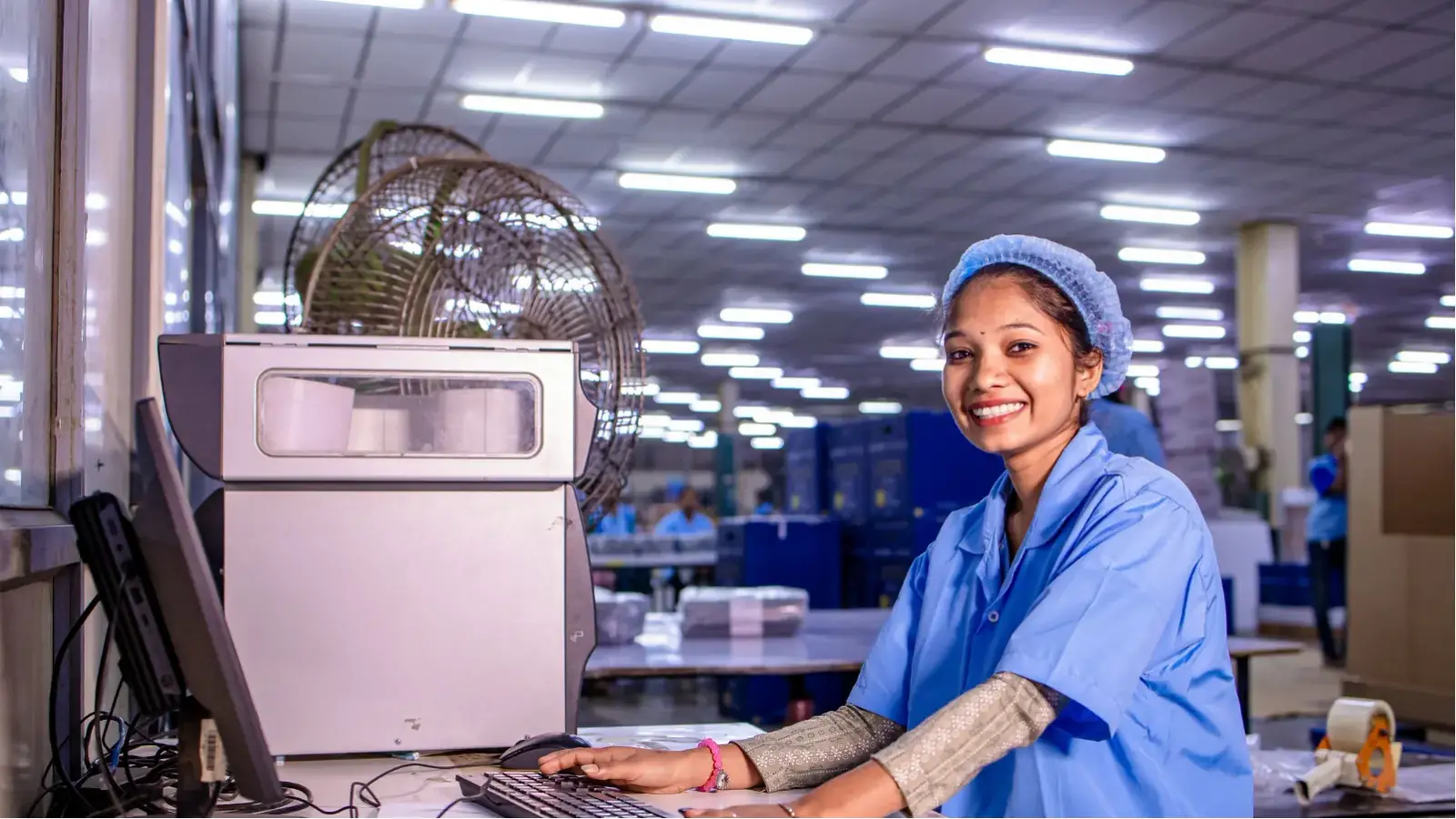 Build an ERP System Around Your Business Processes Operations staff using a computer system on a factory floor