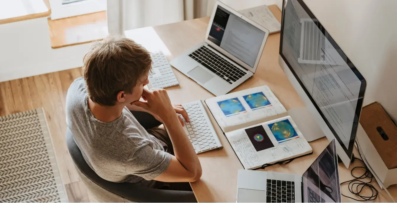 Benefits of Legacy System Modernization Older desktop computer next to a modern laptop